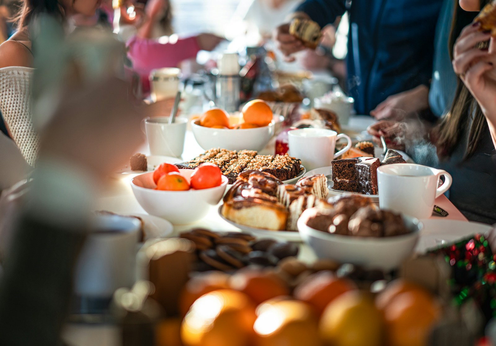 A group of people sitting at a table eating food