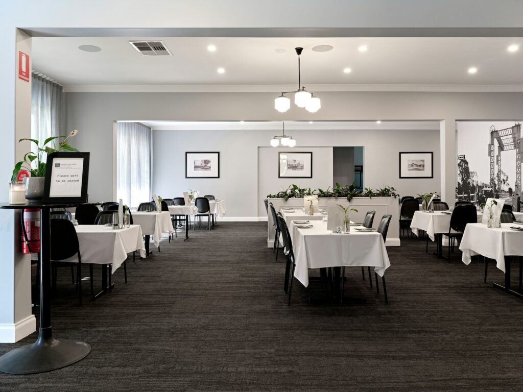 A large dining room with tables and chairs