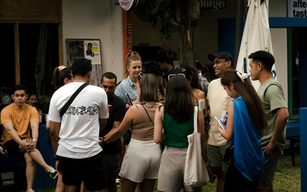 a group of people standing around each other