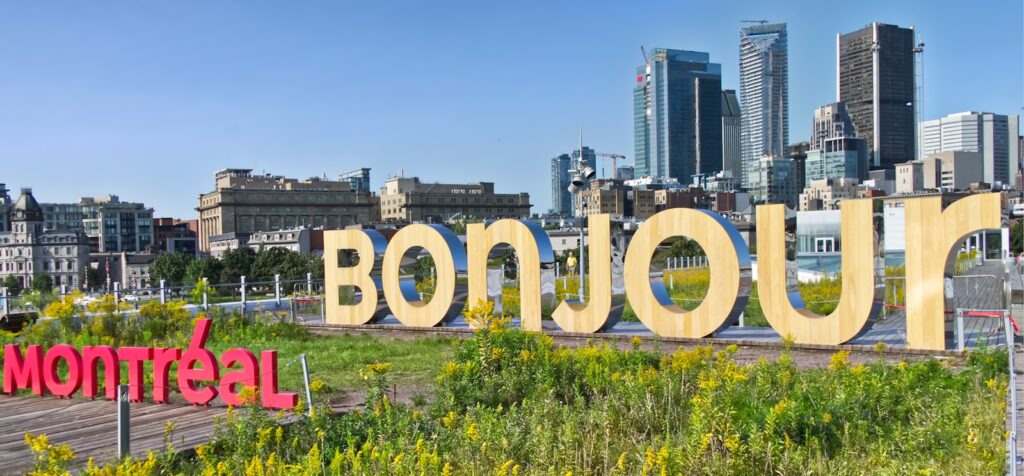 A sign that says bonjou in front of a city